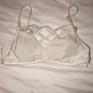 I am selling a white crisscross bathing suit top.